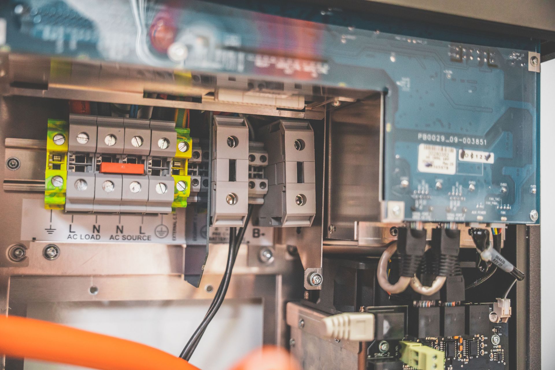 Close-up view of the internal components of a solar inverter showing electrical parts.